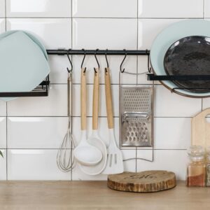Elegant kitchen display featuring utensils, herbs, and dishware for a contemporary look.